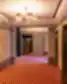 Grand Poet Hotel by Semarah viešbučio koridorius su liftų zona ir raštuotu kilimu.