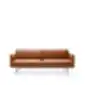 New York sofa with brown leather upholstery and slim metal legs.