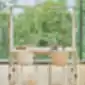 Mobile desk with transparent acoustic screen by a window overlooking nature.
